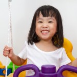 school-aged children dental school-aged girl smiling and playing at dental clinic in Glebe, NSW