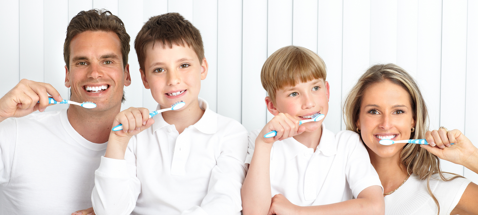 Healthy Teeth young family smiling brushing their teeth