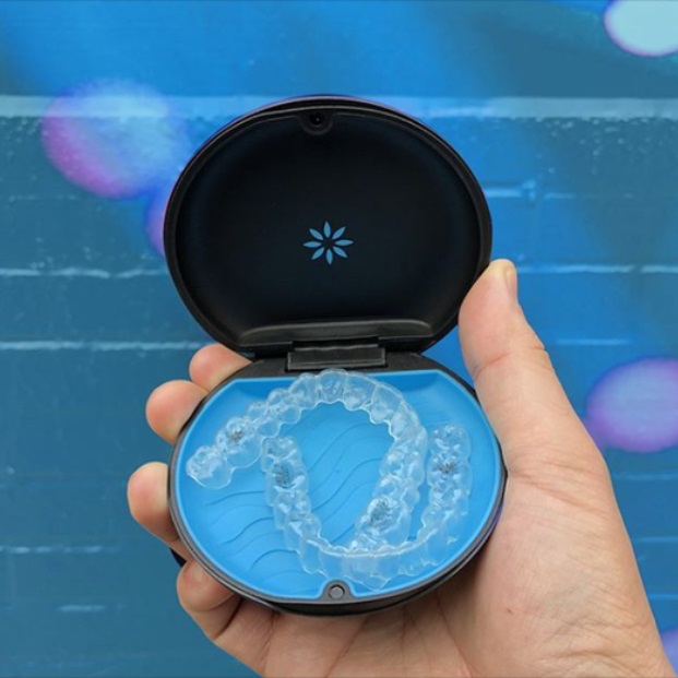 invisalign in the box fits on the palms of a hand