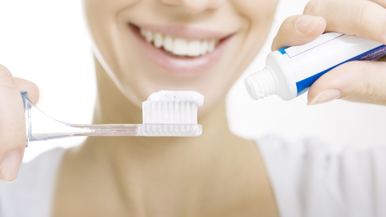 Woman with Toothbrush | Dental Crowns Booragoon WA